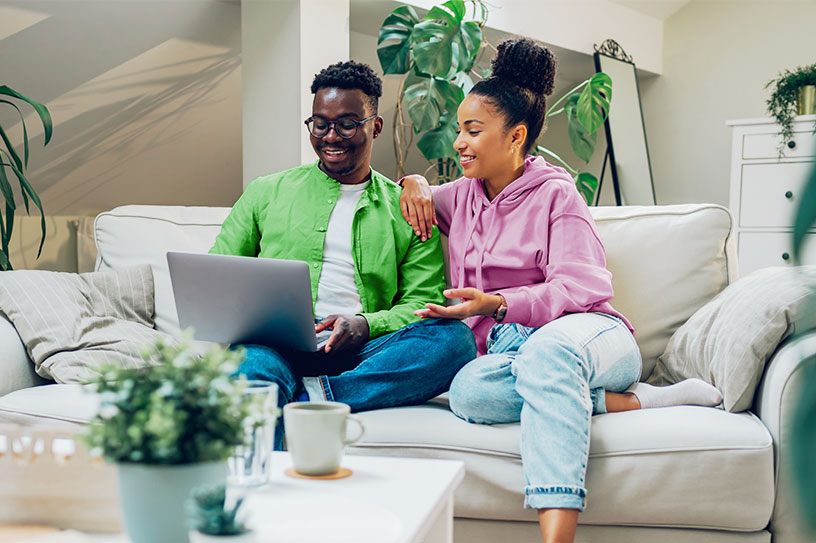 Young woman celebrating after consolidating her debt.